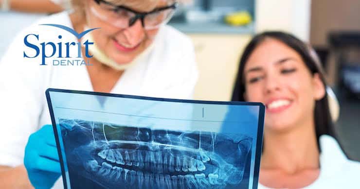 Dentist going over x-ray with client