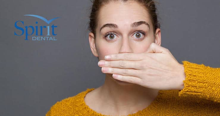 Lady covering her mouth with her hand