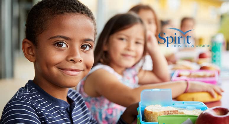 kids smiling in a classroom before eating lunch