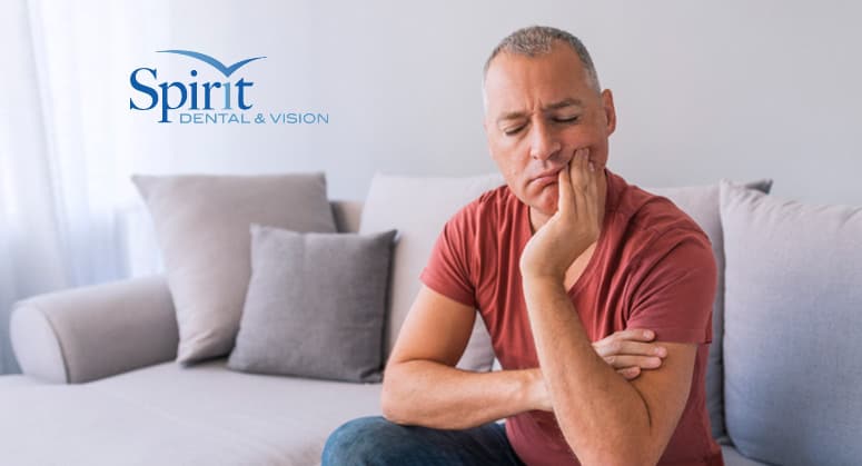 Man holding mouth after chipping tooth.