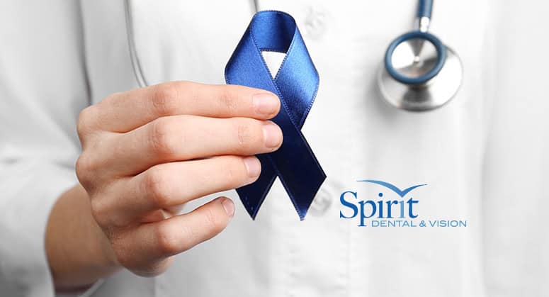 Doctor holding a cancer ribbon