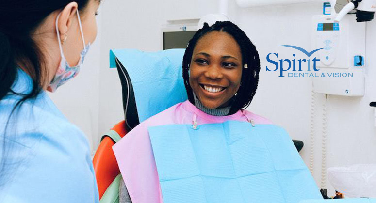 Lady in dentist chair talking with her dentist