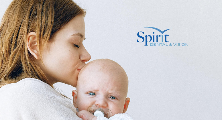 Mother kissing baby on the head