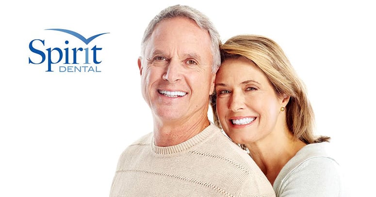 Middle aged man and woman smiling with very nice teeth