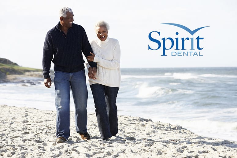 Senior couple walking along the beach