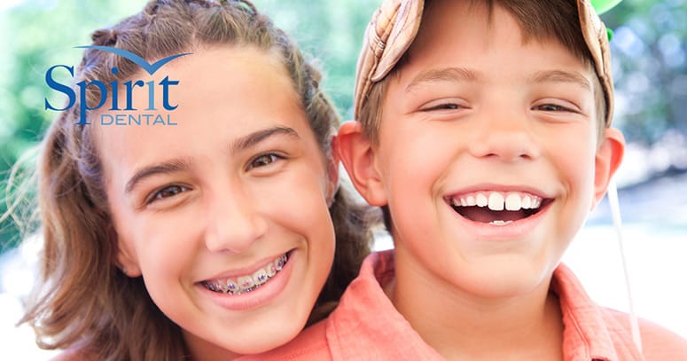 Boy with slightly crooked teeth with his slightly older sister that has braces