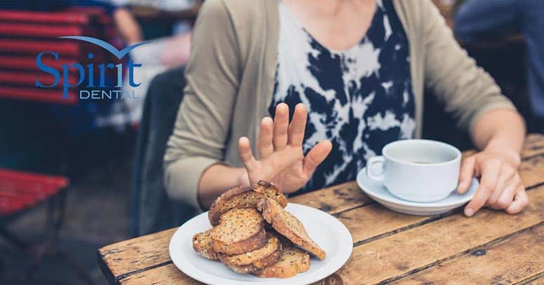 Lady putting her hand up signaling that she wouldn't like any of the bread