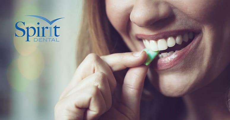 Close up of lady putting a piece of gum in her mouth