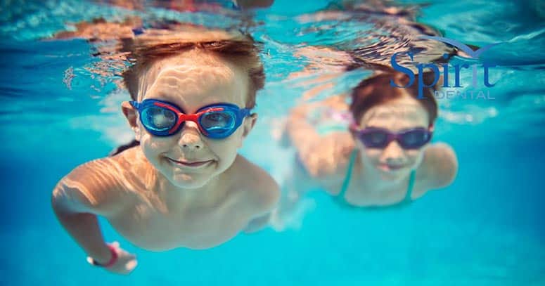 Two kids swimming underwater