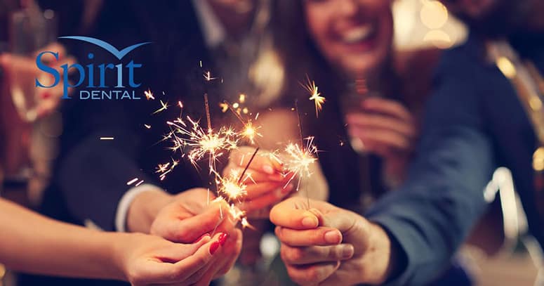 Group of people holding sparklers celebrating