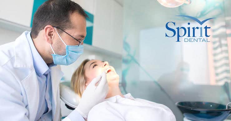 Lady in dentist chair having her teeth looked at